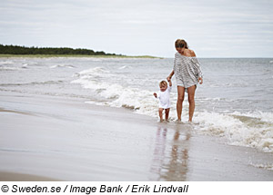 Frau mit Kind am Strand, Ostschweden